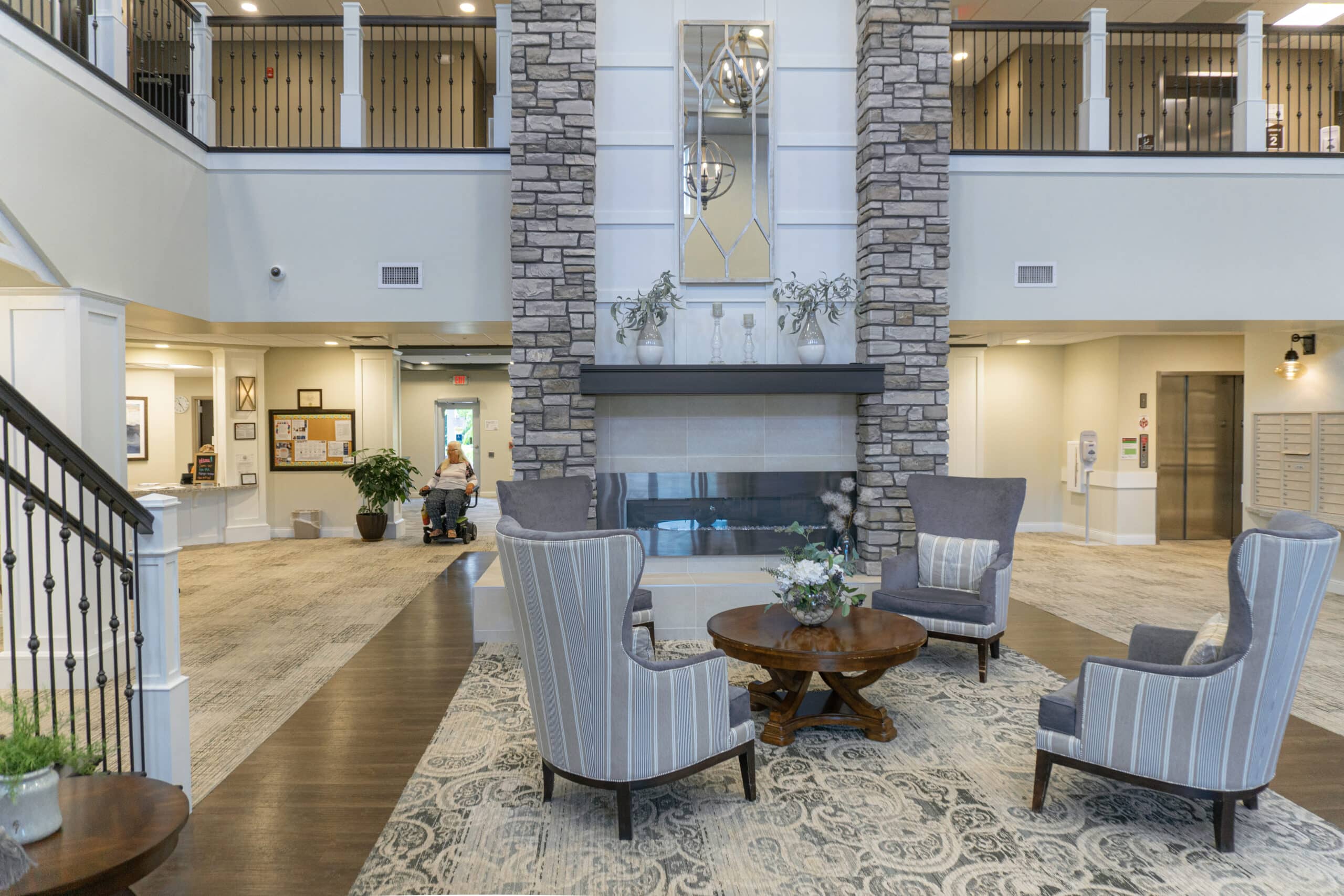 Mc Lobby-4 A Room With A Fireplace And Chairs