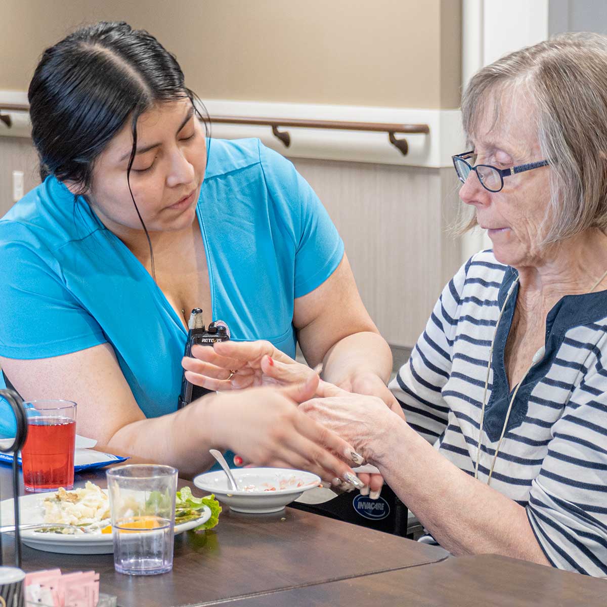Mc-Memory-Care-15-Cropped A Woman Applying A Hand Cream To An Older Woman